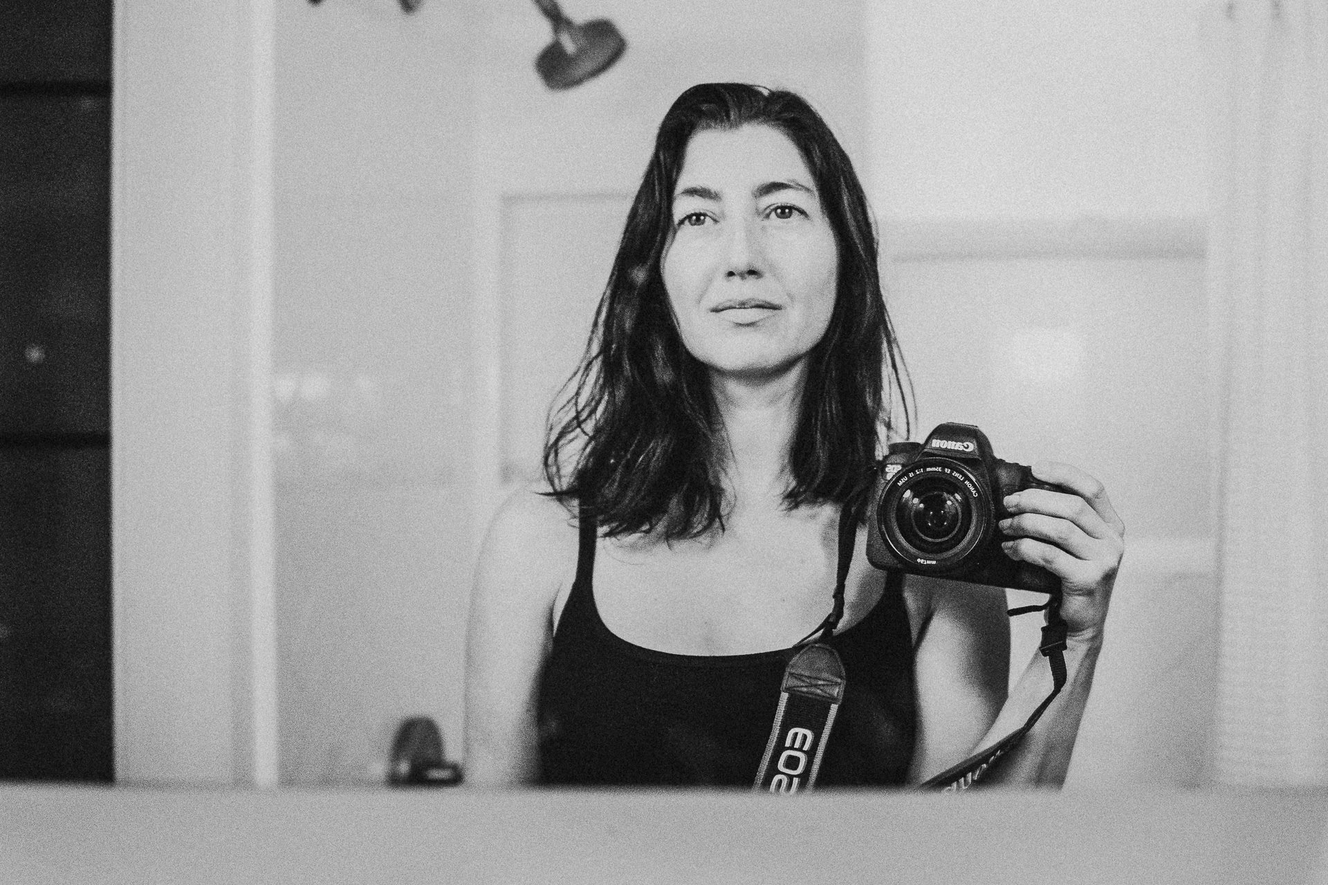 Sarah Sido Portrait in Black and White Holding Camera