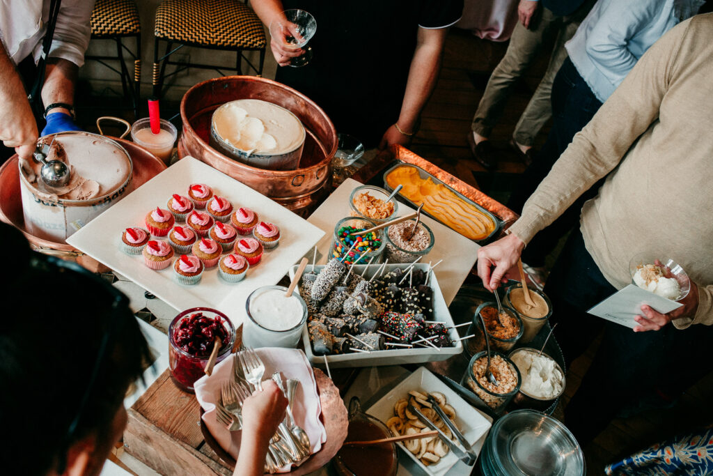 Guests gather around a dessert bar at the party in Los Angeles, CA