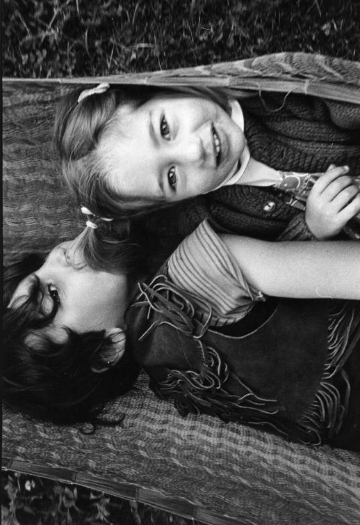 Sarah as a little kid in a hammock with her brother in Vermont