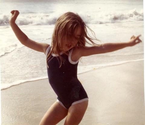 Sarah as a little kid on the beach