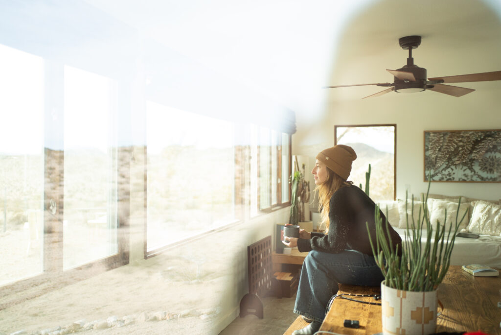 Woman in Beanie Looking Out Window