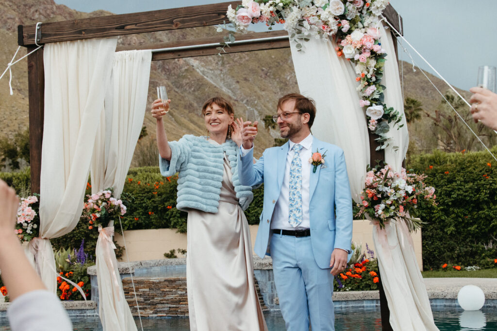 Bride and groom make a toast after their ceremony in Palm Springs, CA