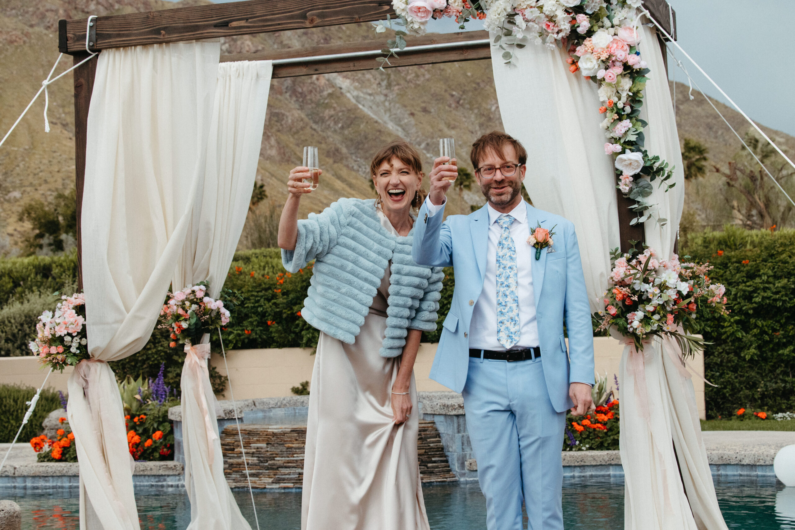 Bride and groom make a champagne toast after their ceremony in Palm Springs, CA