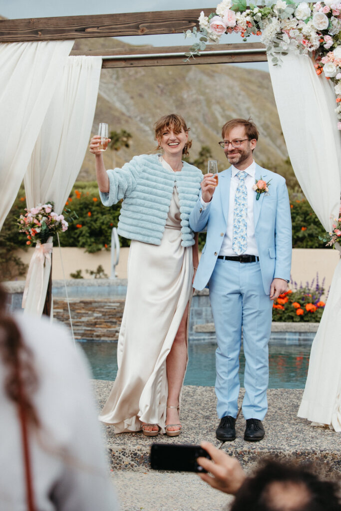 Photo of a just married couple giving a toast at their wedding in Palm Springs, CA