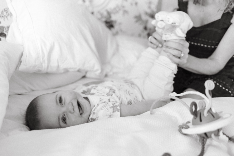 Baby laying on bed before parents wedding