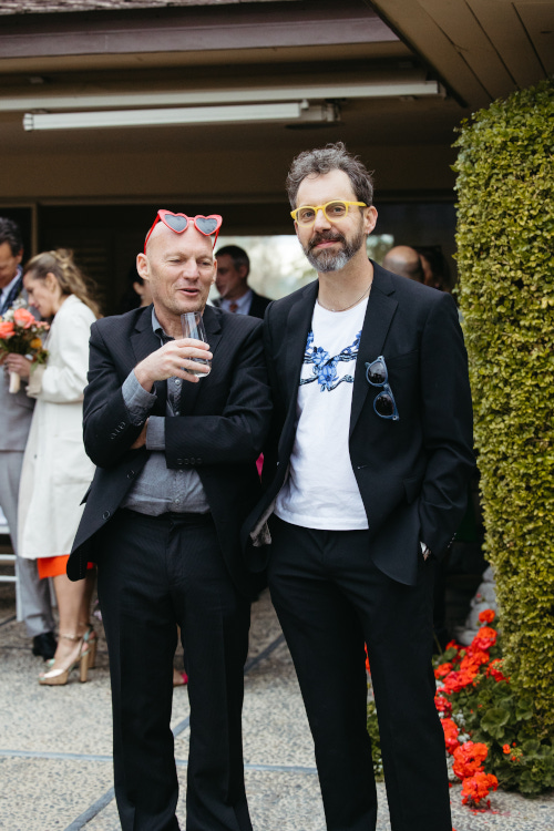 Two men with fun glasses in suits at wedding