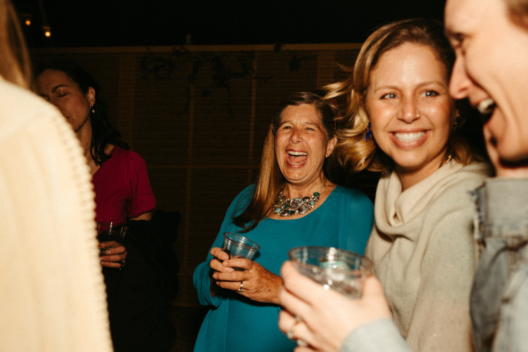 Wedding guests laughing at wedding