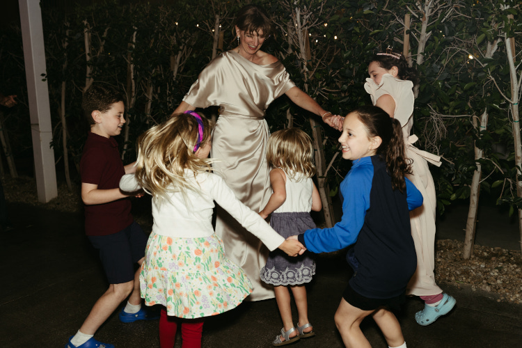 Bride dancing in circle with kids